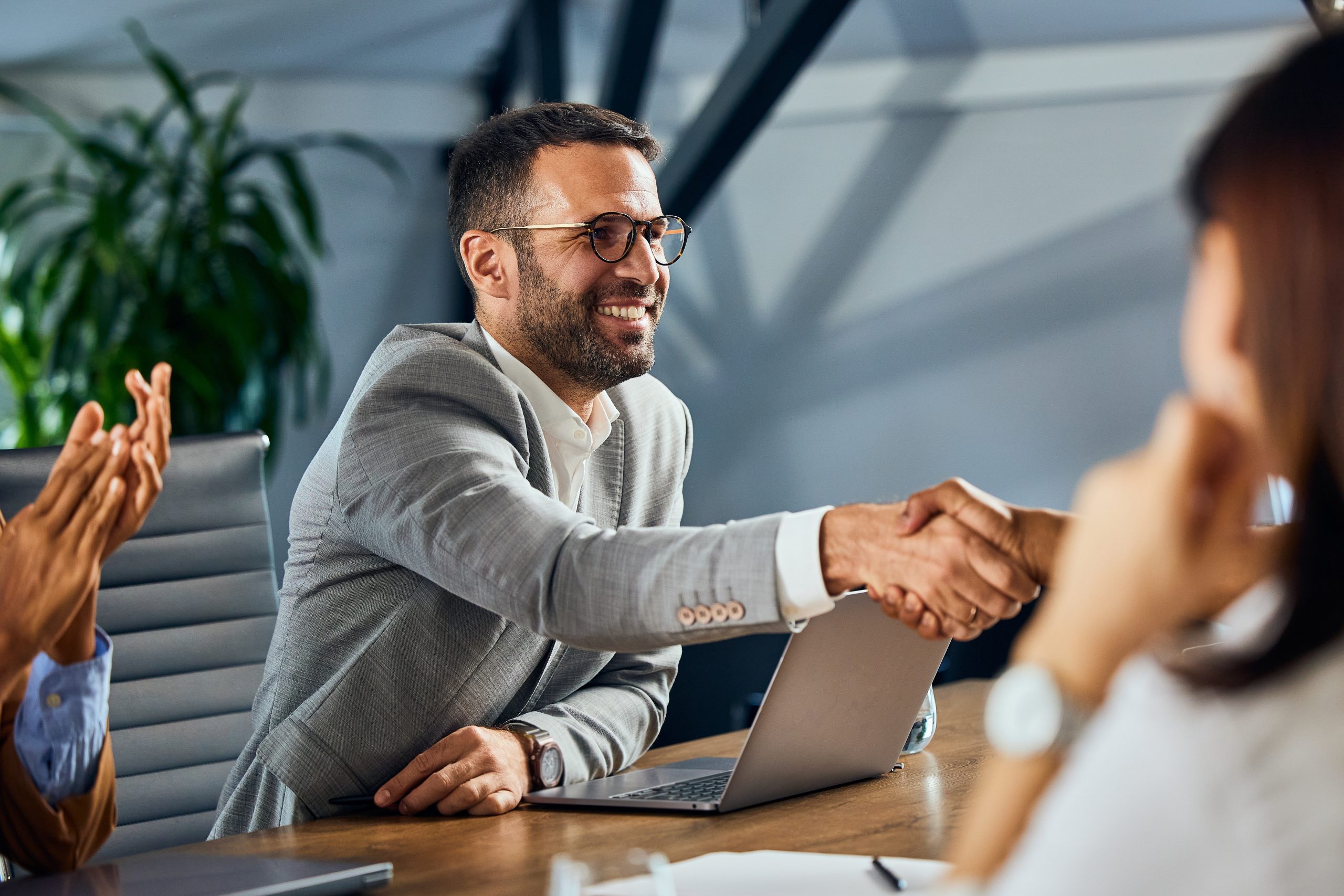 A,Smiling,Businessman,Doing,A,Handshake,During,The,Meeting,,In