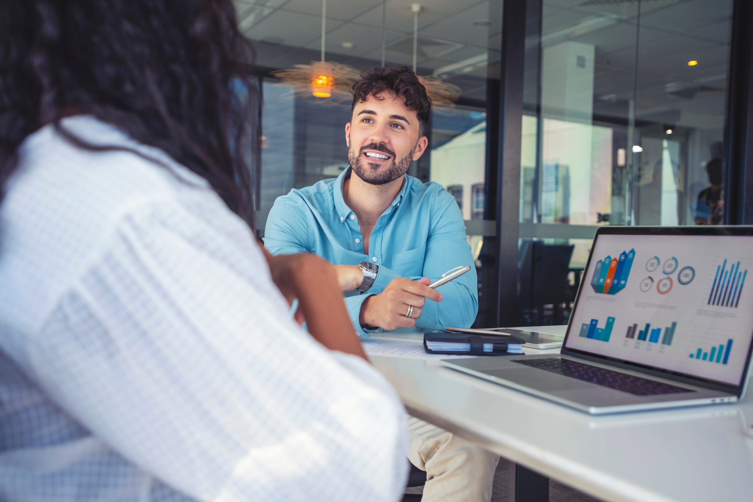 financial-advisor-presenting-data-charts-laptop-client-wolf-and-company